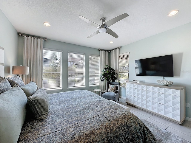 tiled bedroom with ceiling fan, multiple windows, recessed lighting, and a textured ceiling