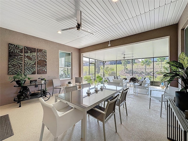 dining space featuring a textured wall, ceiling fan, recessed lighting, and a sunroom