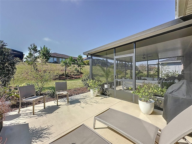 view of patio featuring a sunroom and a grill