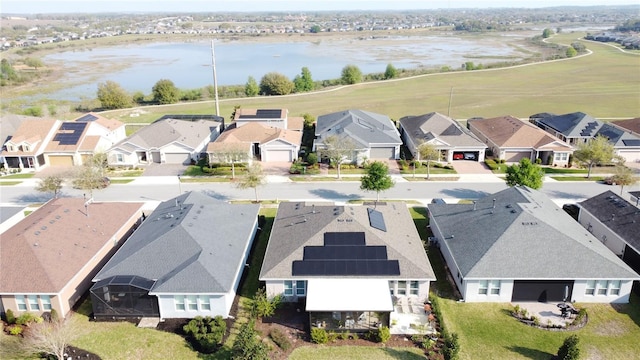 drone / aerial view with a residential view and a water view