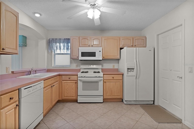 1135 Santa Cruz Dr, The Villages, FL 32162 - kitchen with white appliances, light countertops, light brown cabinetry, and a sink