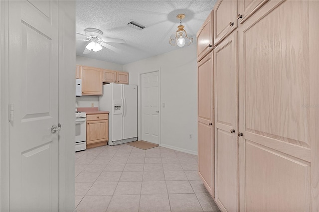 1135 Santa Cruz Dr, The Villages, FL 32162 - kitchen with visible vents, light brown cabinets, white appliances, a textured ceiling, and a ceiling fan