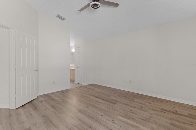 1135 Santa Cruz Dr, The Villages, FL 32162 - unfurnished room featuring visible vents, lofted ceiling, a ceiling fan, light wood finished floors, and baseboards