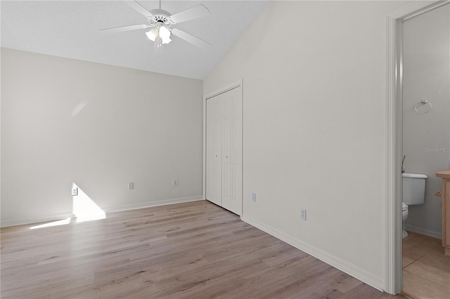 1135 Santa Cruz Dr, The Villages, FL 32162 - unfurnished bedroom featuring vaulted ceiling, baseboards, a closet, and light wood finished floors