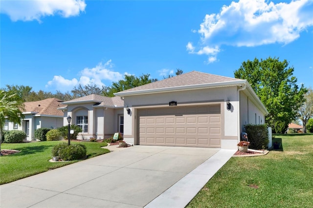 view of front facade featuring a front yard, an attached garage, concrete driveway, and stucco siding