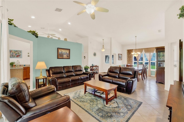 living area with light tile patterned floors, visible vents, lofted ceiling, recessed lighting, and ceiling fan with notable chandelier