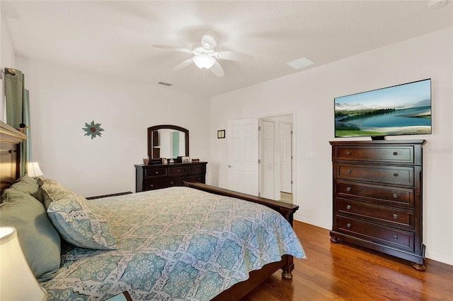 bedroom with visible vents, ceiling fan, and wood finished floors