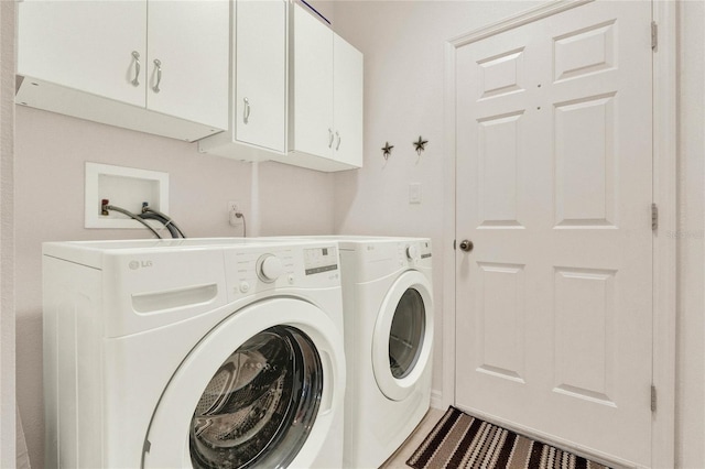 washroom featuring cabinet space and separate washer and dryer