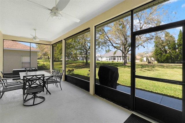 sunroom / solarium with a wealth of natural light and ceiling fan