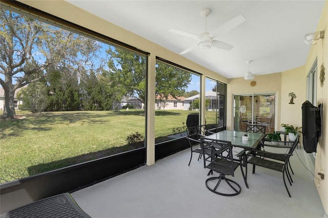 sunroom / solarium with a ceiling fan