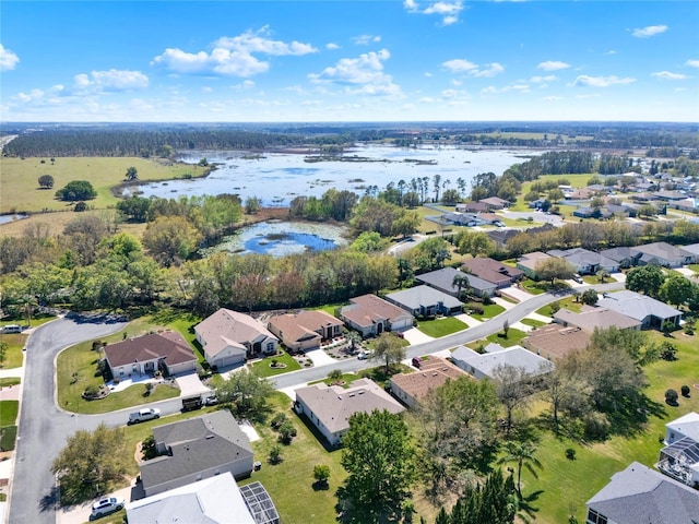 drone / aerial view featuring a residential view and a water view