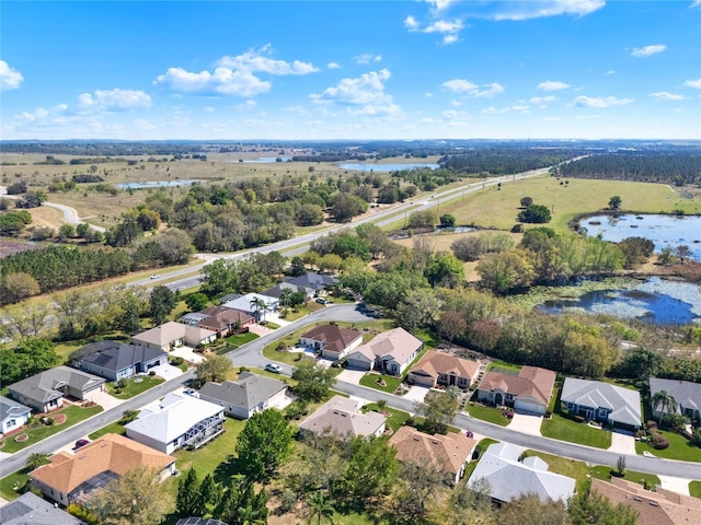 drone / aerial view with a residential view and a water view