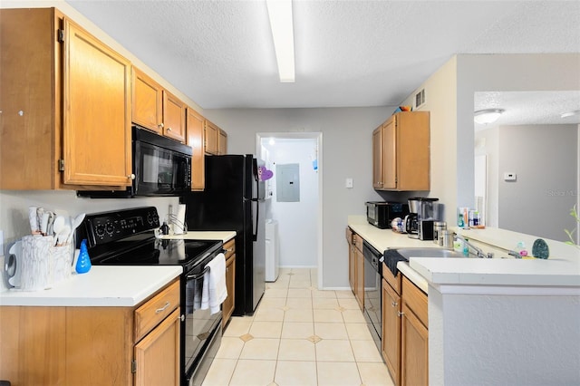 kitchen with visible vents, black appliances, light countertops, light tile patterned floors, and a textured ceiling