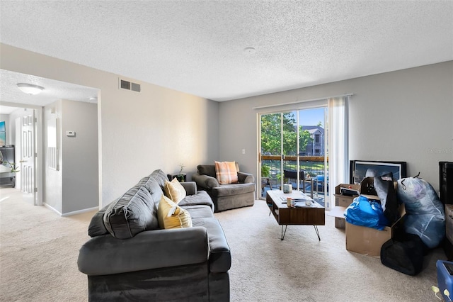 living room featuring visible vents, light colored carpet, a textured ceiling, and baseboards