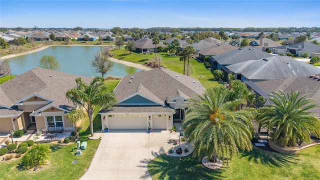 drone / aerial view with a residential view and a water view