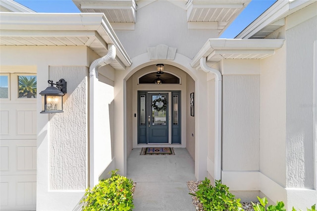 view of exterior entry with a garage