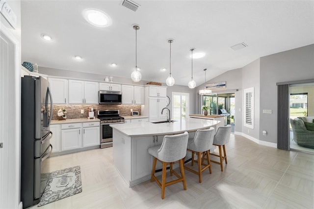 kitchen featuring visible vents, backsplash, white cabinetry, appliances with stainless steel finishes, and light countertops