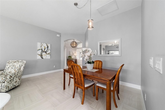 dining room featuring visible vents, arched walkways, and baseboards