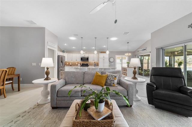 living area with baseboards, visible vents, recessed lighting, vaulted ceiling, and ceiling fan with notable chandelier