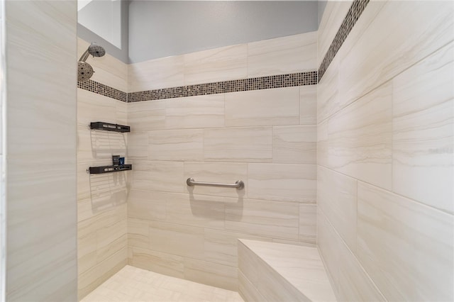 full bath with a tile shower