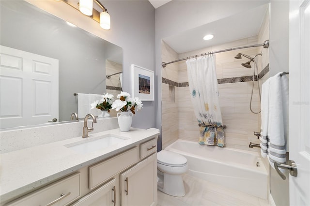 full bath featuring vanity, toilet, and shower / tub combo