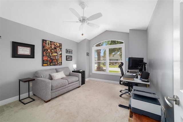 carpeted office with vaulted ceiling, a ceiling fan, and baseboards