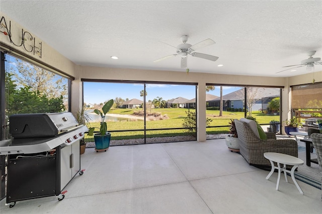 sunroom featuring a ceiling fan