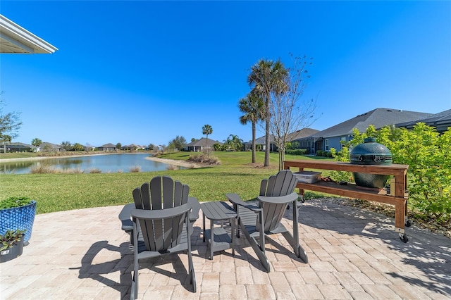 view of patio featuring grilling area and a water view