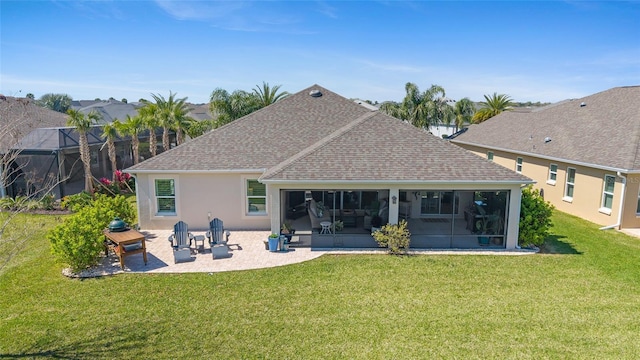 back of house featuring a patio, roof with shingles, a yard, a sunroom, and stucco siding