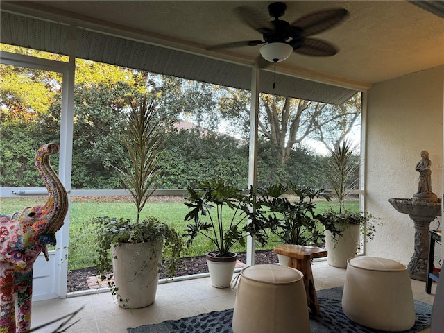 unfurnished sunroom with ceiling fan