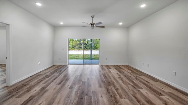 unfurnished room featuring recessed lighting, a ceiling fan, baseboards, and wood finished floors