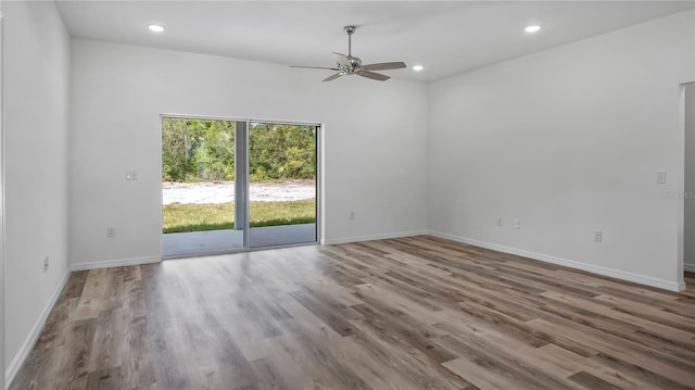 spare room with recessed lighting, a ceiling fan, baseboards, and wood finished floors