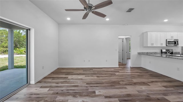 kitchen featuring visible vents, recessed lighting, appliances with stainless steel finishes, wood finished floors, and white cabinetry