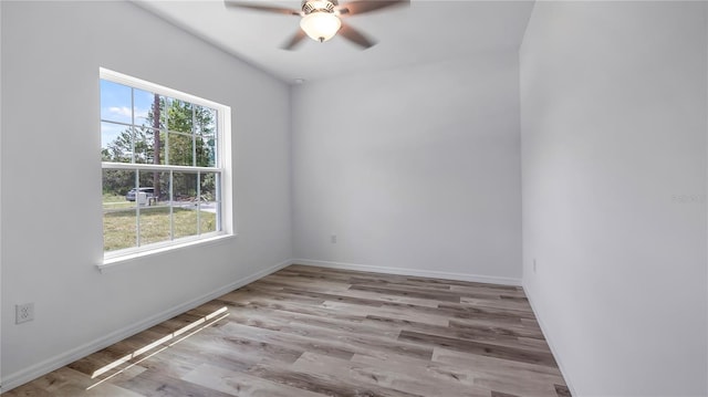 empty room featuring a ceiling fan, wood finished floors, and baseboards