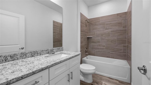 full bath featuring vanity, toilet, wood finished floors, and bathtub / shower combination