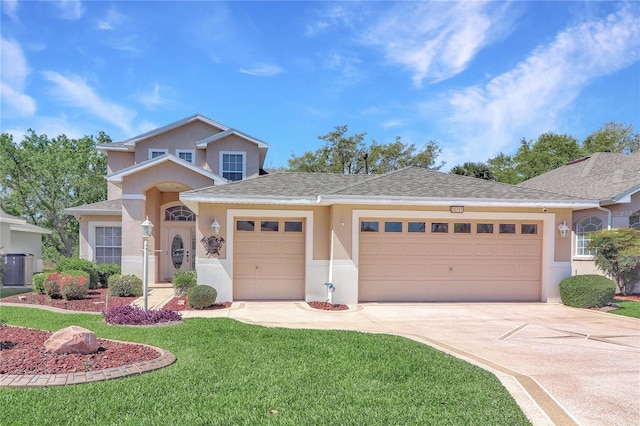 view of front of home with stucco siding, a front lawn, roof with shingles, concrete driveway, and a garage