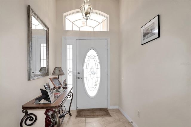 foyer entrance with baseboards and plenty of natural light