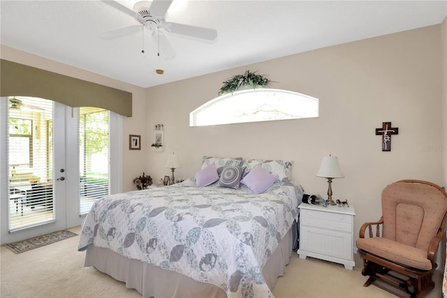 bedroom with ceiling fan, access to exterior, multiple windows, and light carpet