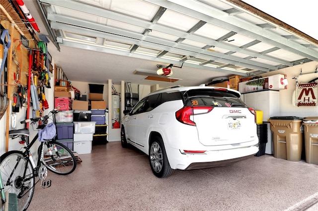 garage with water heater and a garage door opener