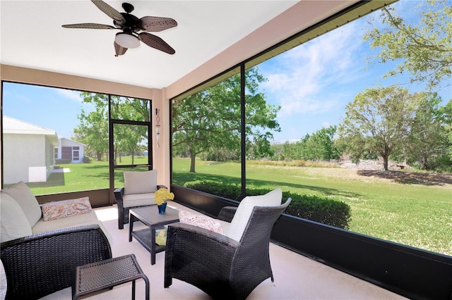 sunroom / solarium featuring a ceiling fan