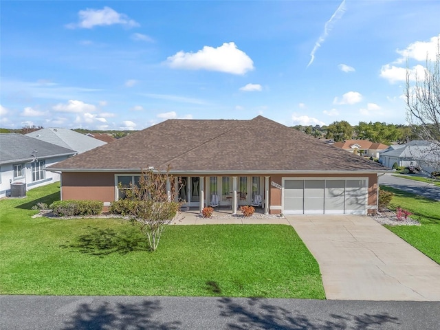 ranch-style home featuring a garage, a front yard, cooling unit, and concrete driveway
