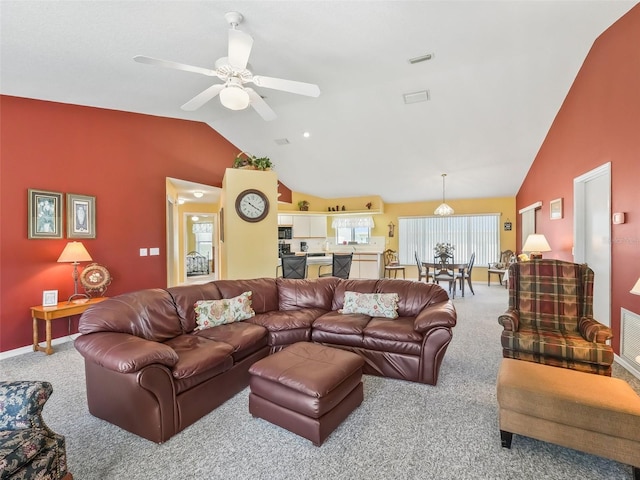 carpeted living room featuring visible vents, baseboards, ceiling fan, and vaulted ceiling