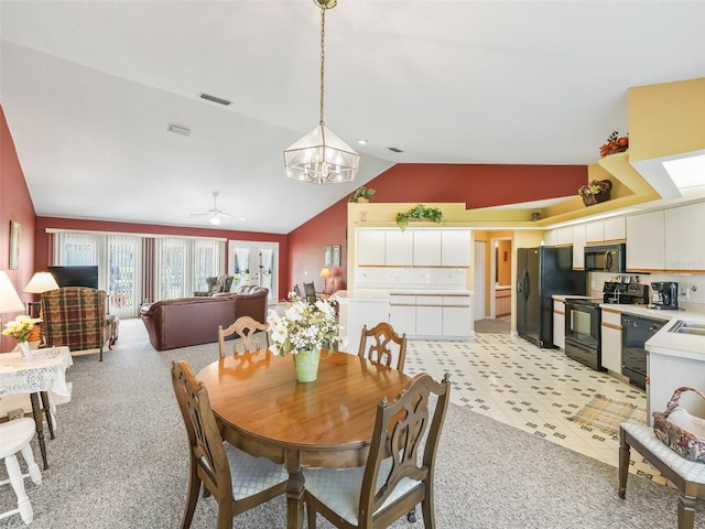 dining room featuring visible vents, lofted ceiling, and ceiling fan with notable chandelier