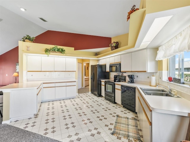 kitchen with visible vents, light countertops, a peninsula, black appliances, and a sink