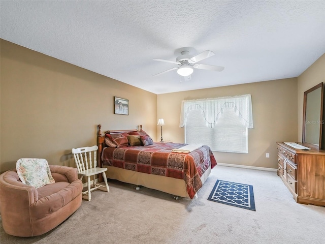 carpeted bedroom with baseboards, a textured ceiling, and ceiling fan