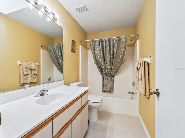 bathroom with vanity, visible vents, a textured ceiling, tile patterned floors, and toilet