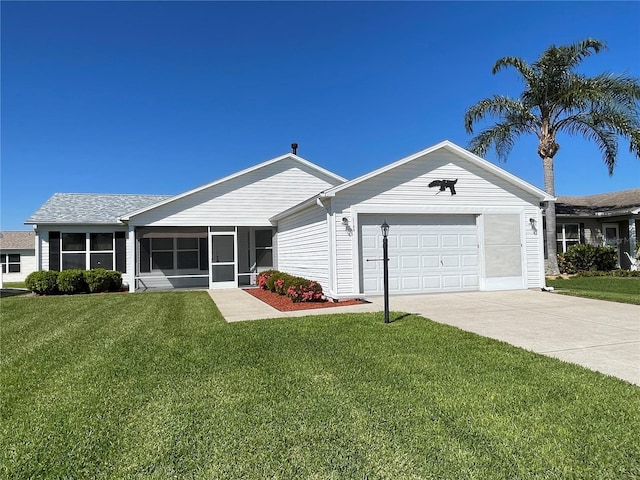 ranch-style home featuring a front yard, a sunroom, an attached garage, and driveway