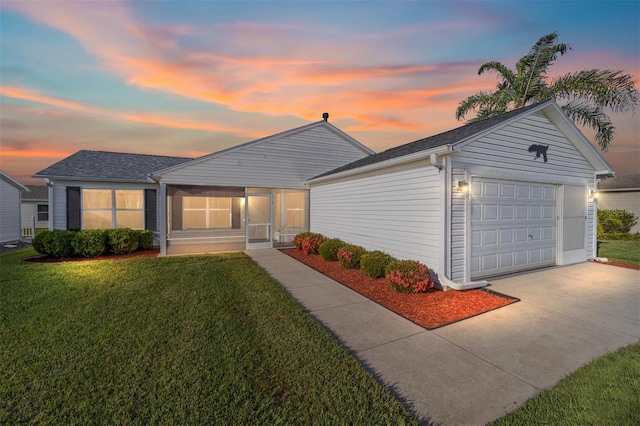 ranch-style home with driveway, an attached garage, a sunroom, a front lawn, and an outdoor structure