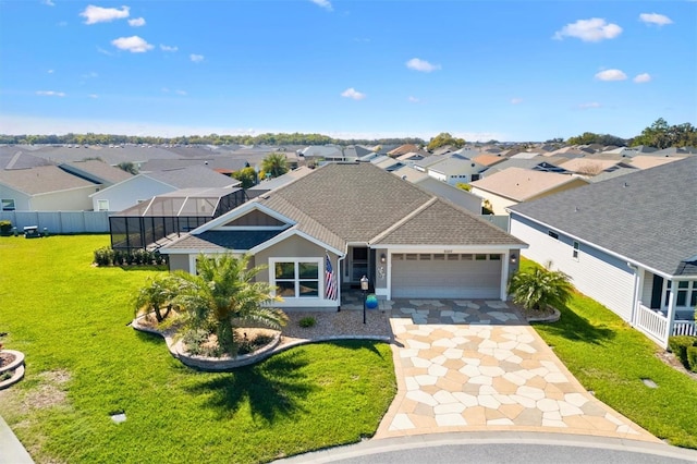 6088 Keckonen Dr, The Villages, FL 32163 - view of front facade featuring a shingled roof, a residential view, concrete driveway, a front yard, and an attached garage