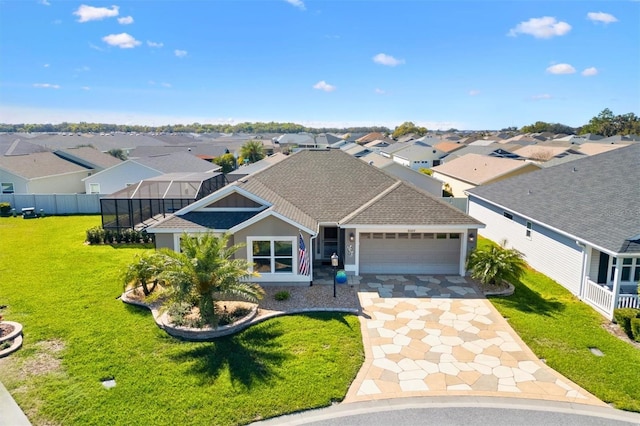 view of front facade featuring a shingled roof, a residential view, concrete driveway, a front yard, and an attached garage